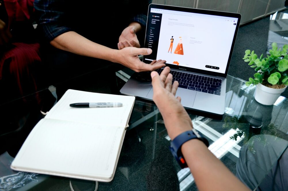 Photo by UX Indonesia person using macbook pro on white table